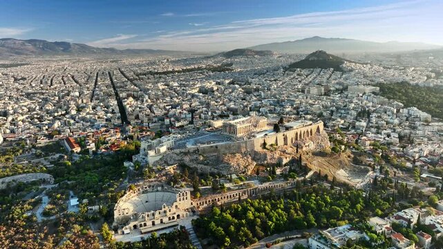 The Acropolis and Parthenon stand above the city of Athens, Greece. Drone aerial view shows the historic Acropolis ruins in Athens, Greece