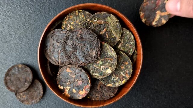 Organic Chinese green pu-erh tea with various herbs in round bricks. Chinese pu-erh tea as a background for your design