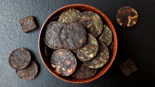 Organic Chinese green pu-erh tea with various herbs in round bricks. Chinese pu-erh tea as a background for your design