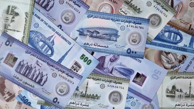 United Arab Emirates cash, paper dirhams, and coins for exchange and financial transactions. UAE currency as a background for your design