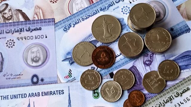 United Arab Emirates cash, paper dirhams, and coins for exchange and financial transactions. UAE currency as a background for your design