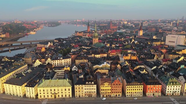 Colorful historic buildings fill Gamla Stan in Stockholm, Sweden. Evening light hits the old town district of Stockholm, Sweden. Panoramic city aerial, 4K UHD