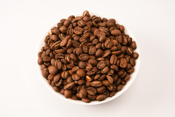 Fototapeta premium Coffee beans on a white background. Top view. Coffee beans texture.