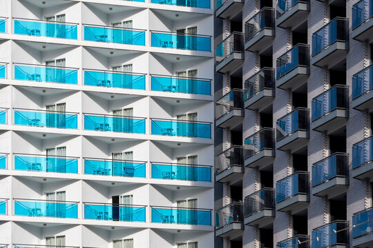 Residential architecture in spain featuring a modern glass apartment building where balconies and facade pattern create crisp geometry and rhythm