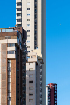 Urban architecture in spain where modern highrise towers and buildings rise vertical with a facade of apartments creating a graphic skyline