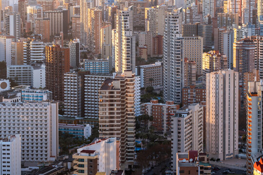 City skyline in spain shows urban density where highrise buildings and apartments form architecture with repeating facades across the horizon