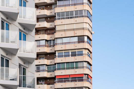 Residential architecture in spain highlights a modern apartment building facade of concrete where balconies create a strong pattern and rhythm