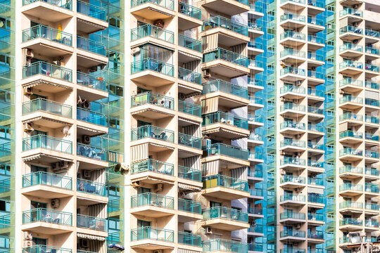 Residential architecture in spain featuring modern apartment building facade where balconies and windows form a clean pattern and graphic texture