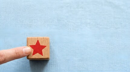 Hand Gesture Touching Red Star Block Blue Bokeh Soft-Focus Background Dynamic Lighting Minimalist Design Capturing Scale Contrast Wood Grain Texture