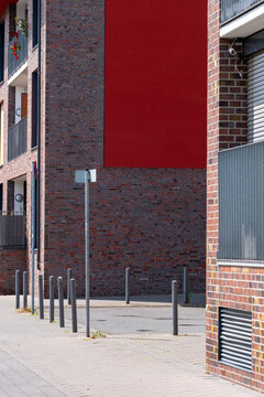 Modern industrial urban street corner with brick wall and empty pavement showing strong lines for wayfinding and minimal city architecture background