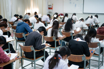 Obraz premium Students Taking Exam in Classroom Focused on Writing