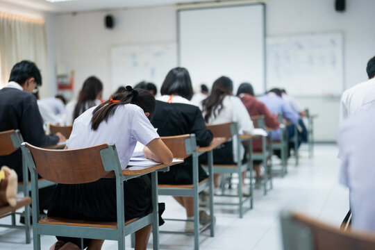 Students Taking Exam in Classroom Focused on Writing