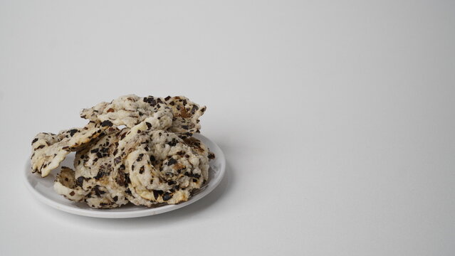 Tike chips or keripik tike, a traditional snack from Indramayu, Indonesia, made from nutgrass tubers, served on a white plate.