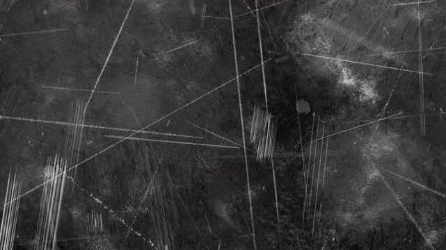 4K Cinematic dark grunge texture overlay featuring heavy intersecting white scratches, clustered scrape marks, and cloudy dust on a black background for VFX compositing.