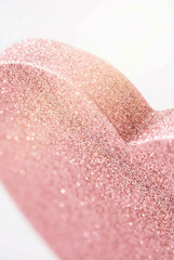 Fototapeta premium Close up of a pink glitter heart decoration for valentines day and romantic celebrations.