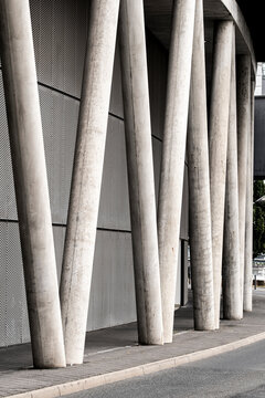 Street perspective through a colonnade of columns as abstract architecture with modern minimal lines and repetition creating calm urban depth