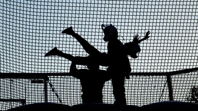 People experiencing simulated skydiving in an indoor wind tunnel generating uplift