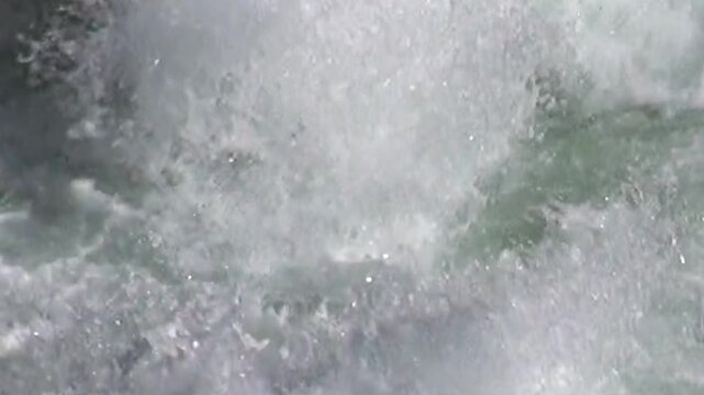 Turbulent water churns and foams as it rushes through a section of rapids. Captured in Yellowstone National Park, the river's unrestrained power creates an awe-inspiring display of nature's strength.