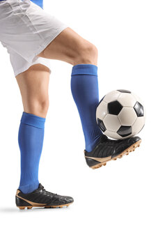 Football player balancing a ball on his foot