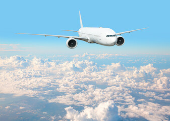 Fototapeta premium White passenger airplane flying in the sky amazing clouds in the background - Travel by air transport