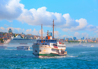 Fototapeta premium Cruise ship and ferry (steamboat) traffic in the Bosphorus - Sea voyage with old ferry (steamboat) on the Bosporus - Coastal cityscape with modern buildings under cloudy sky - Istanbul, Turkey 