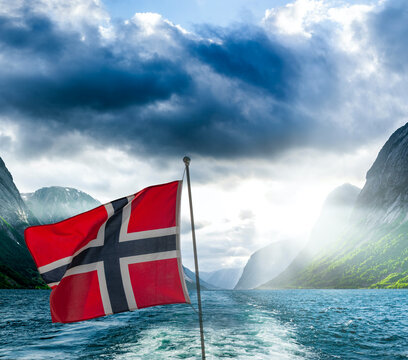 Norwegian ship flag on a ship in a fjord in Norway