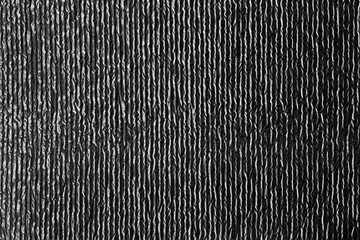 Vertical metallic foil texture with reflective crumpled ridges, ideal for abstract backgrounds, modern design projects, shiny surfaces, and creative visual effects.