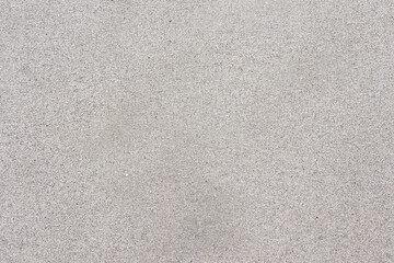 Fototapeta premium Top-down view of clean and fine-grained beach sand. Neutral beige texture offers a minimalist aesthetic.