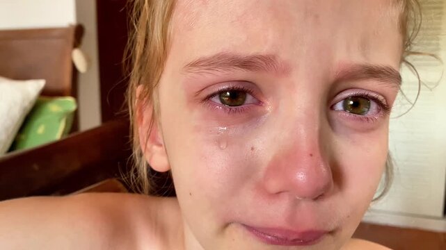  Close-up of a Crying Young Child with a Visible Tear
