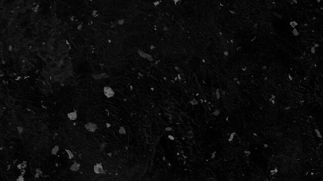 4K Cinematic grunge texture overlay featuring heavy white dust particles, chunky debris, and scattered specks on a black background for VFX compositing.