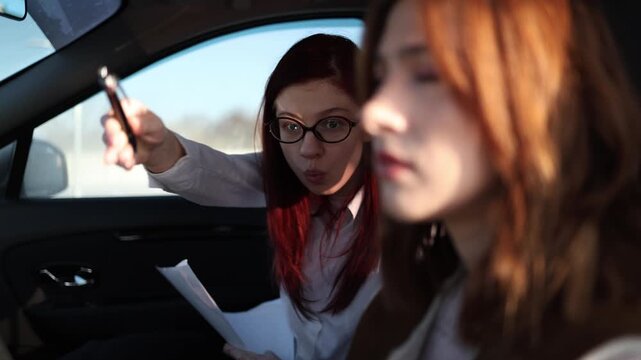 Driving instructor loses temper during car lesson points at notes and dismisses student after mistake while tense atmosphere fills vehicle during stressful training session