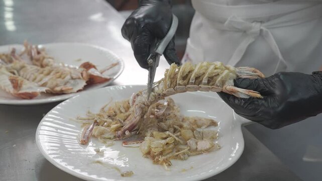 Professional chefs prepare premium mantis shrimp, peeling and cooking this high-quality seafood dish.