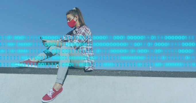 Sitting woman checking phone on concrete ledge in red mask, plaid shirt, binary code, copy space