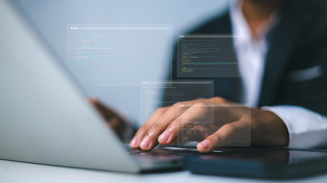 Software developer hands typing code on laptop with digital interface.Professional web programmer working on source code at office desk.Software engineering and application development technology.