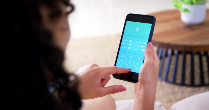 Mother and infant sitting on couch, bringing phone into view and adjusting blue light app controls