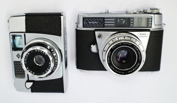 Itterbeck, Germany March 4 2026 - Two vintage cameras are depicted. On the left is an Agfa Optima 1a camera  On the right is a Kodak Retina Automatic II camera, with a Schneider Kreuznach lens 