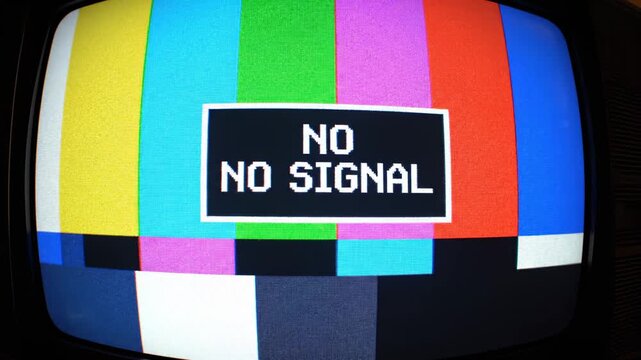 This captures a television screen displaying a static error message with multicolored bars and a black background indicating technical difficulties and a loss of signal.