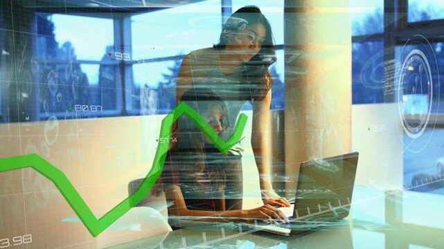Two women working at glass table, seated woman typing laptop triggers business green chart analysis