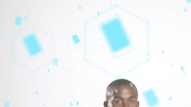 African American man performing overhead swings in studio wielding metal dome prop, shirtless