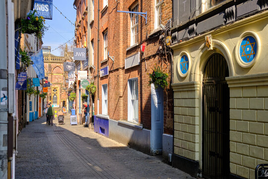 Exeter, United Kingdom  - March 22 2026. Looking along Gandy Street from the high street end, buildings with varied shopfronts line this eclectic independent shopping lane.