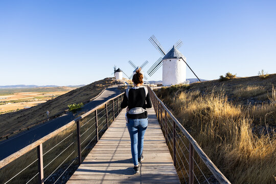 Woman with baby carrier walking to Consuegra windmills