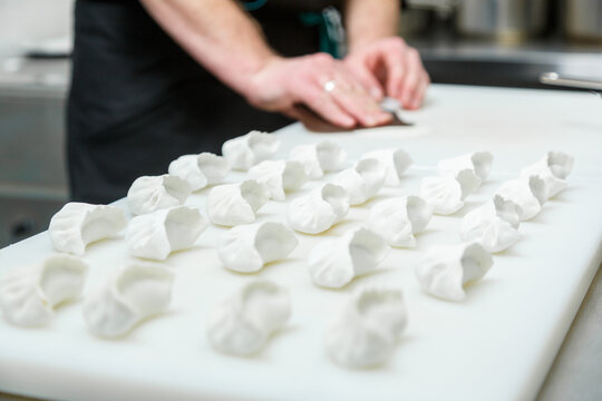 Making Japanese dumplings gyoza on fast food restaurant kitchen