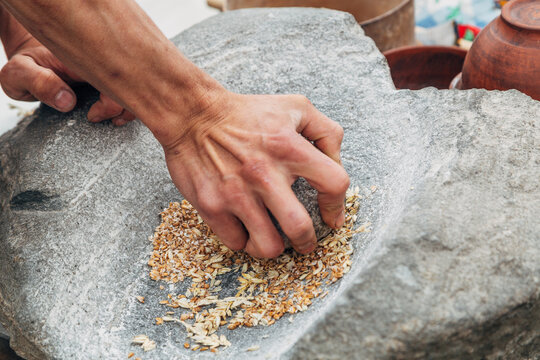 Ancient stone grinding tool with upper and lower stones, used for milling grains