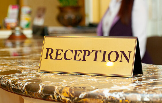 Hotel reception desk sign on a marble counter