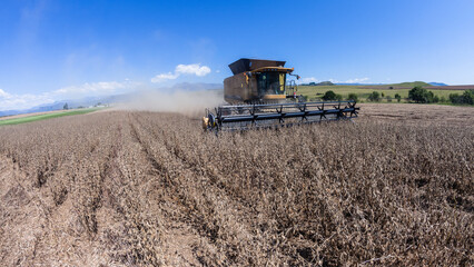 Agriculture Farm Harvester Machine cutting food crops in scenic mountain farmland landscape  © ChrisVanLennepPhoto