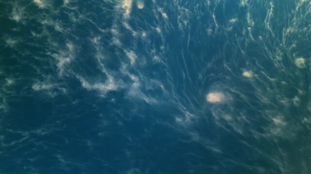 Breathtaking topdown aerial view of deep blue ocean surface featuring mesmerizing swirling patterns of hurricane cyclone at the beginning point, turquoise and teal waters.