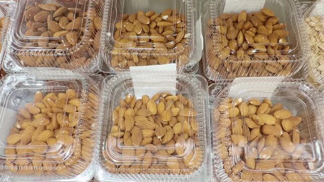 Choosing a variety of nuts at the supermarket