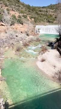 Beautiful emerald green river and waterfall in Spain