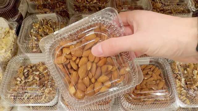 Choosing a variety of nuts at the supermarket