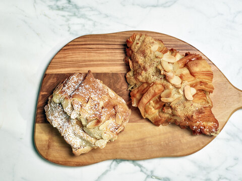 Baked goods dessert almond pastries on wooden plate